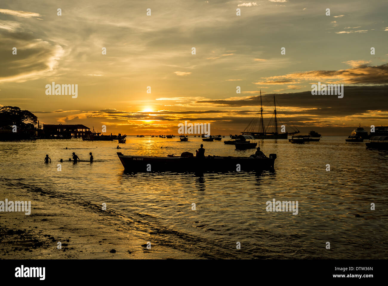 Silhouette of fishermen on the shores of the Indian Ocean during a sunset Stock Photo