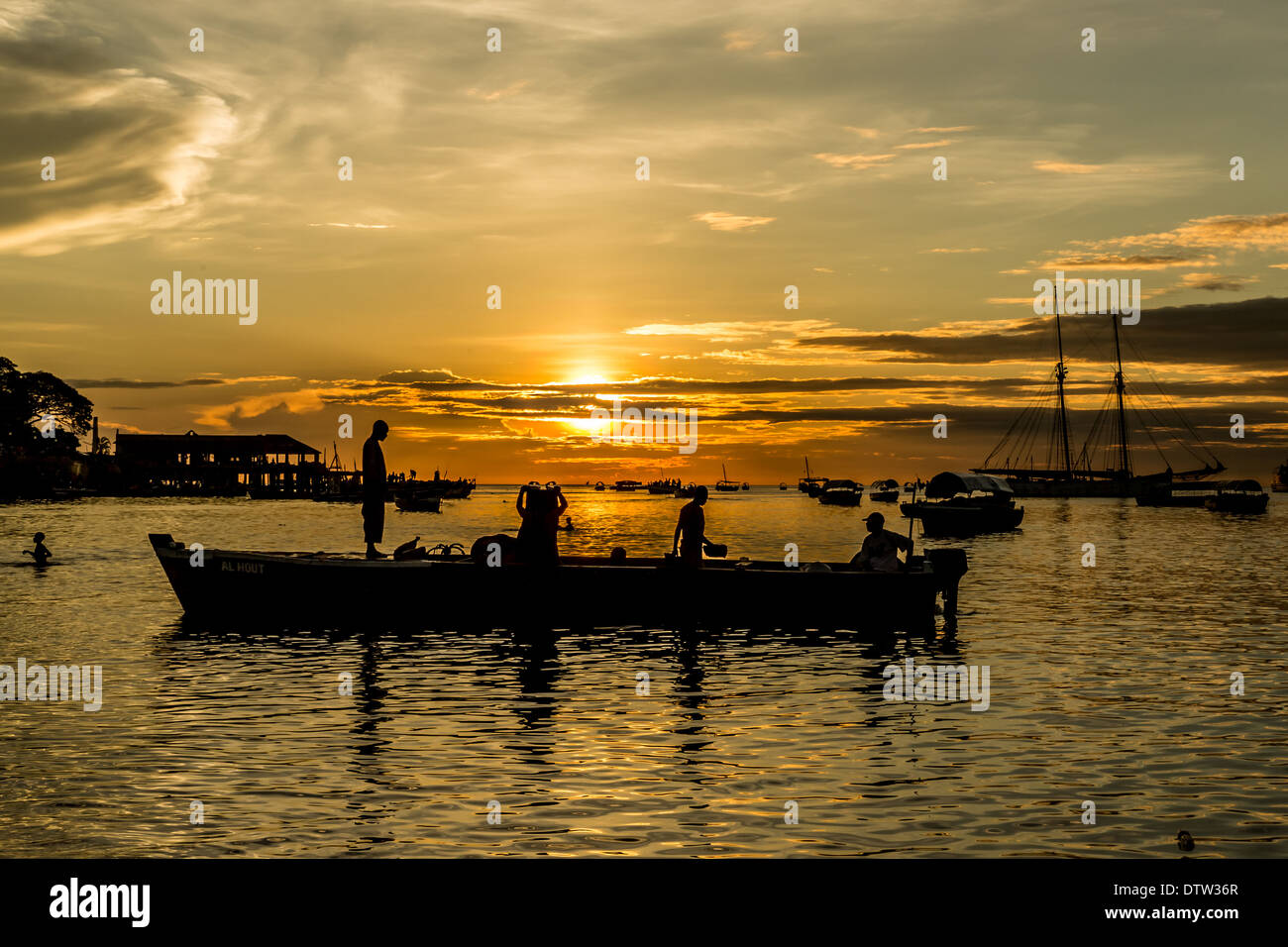 Silhouette of fishermen on the shores of the Indian Ocean during a sunset Stock Photo