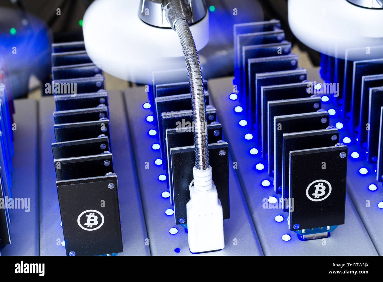 Bitcoin mining USB devices in a row with small fans Stock Photo
