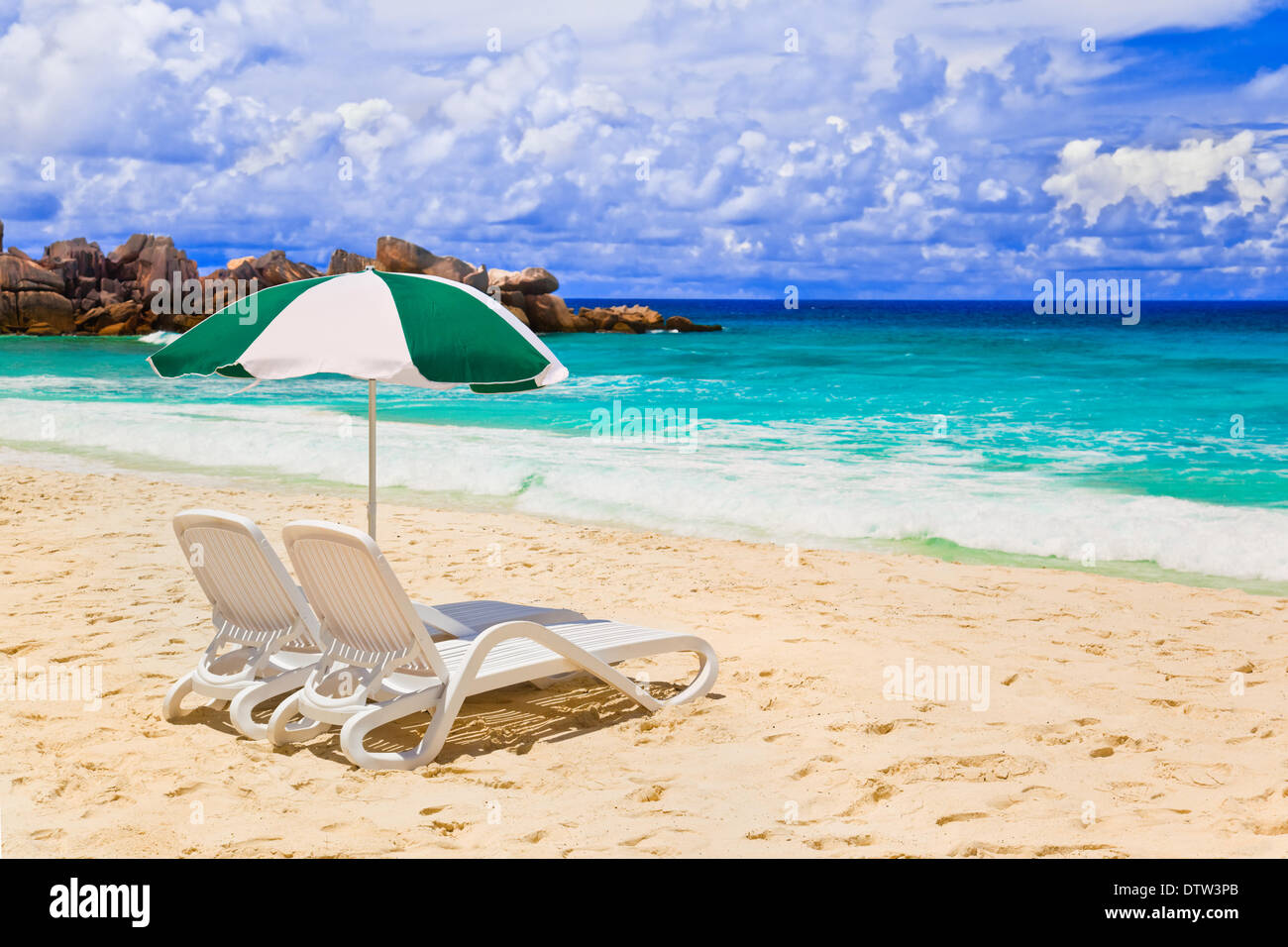 Chairs and umbrella at tropical beach Stock Photo