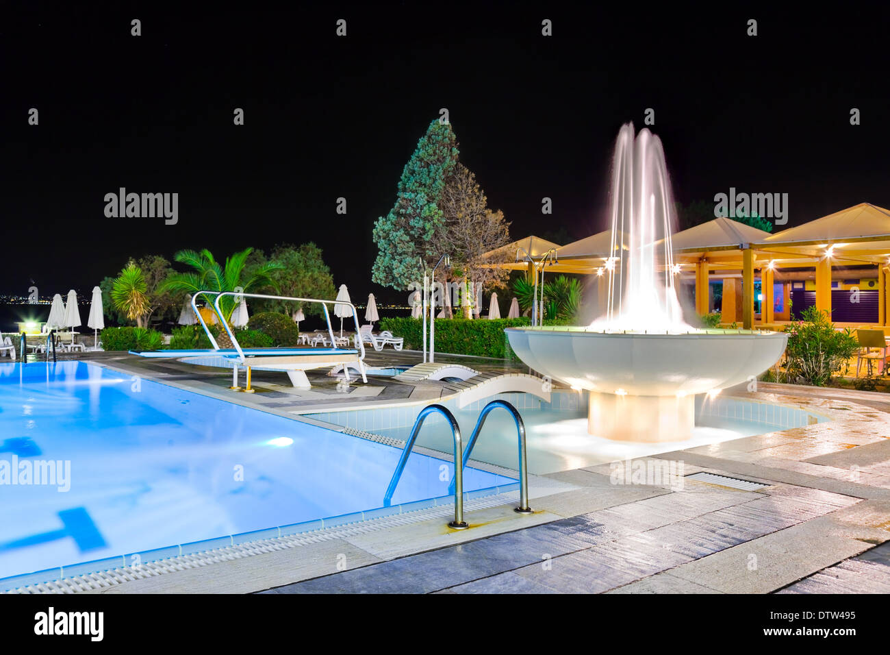 Water pool and fountain at night Stock Photo - Alamy