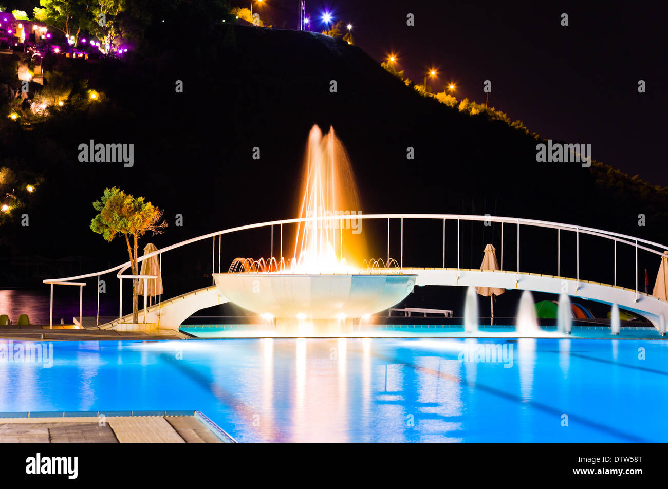 Water pool and fountain at night Stock Photo - Alamy