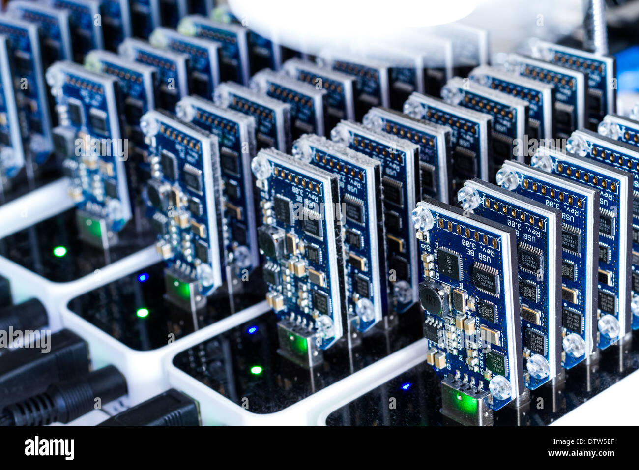Bitcoin mining USB devices in a row with small fans Stock Photo - Alamy