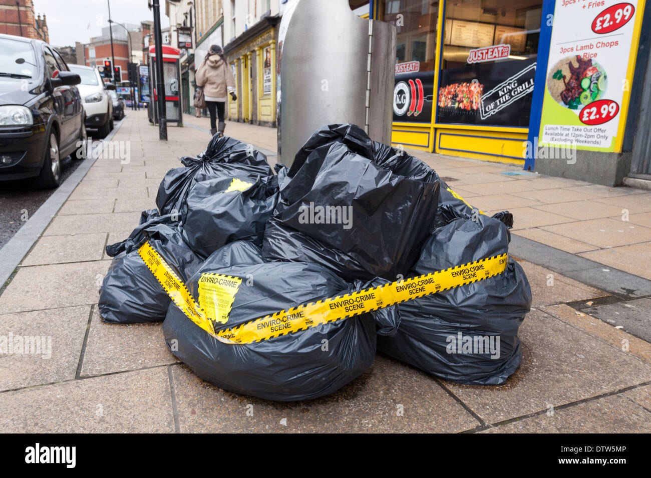 Environmental crime scene. Illegal fly tipping of rubbish bags on a Sheffield city centre street, England, UK Stock Photo