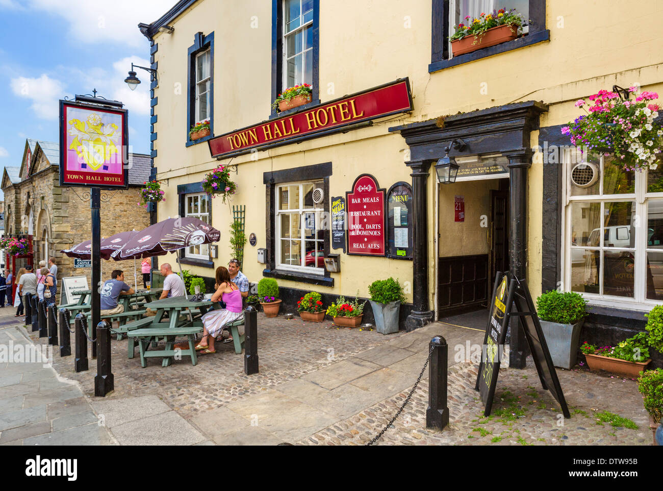 People sitting outside the Town Hall Hotel pub in the historic Market