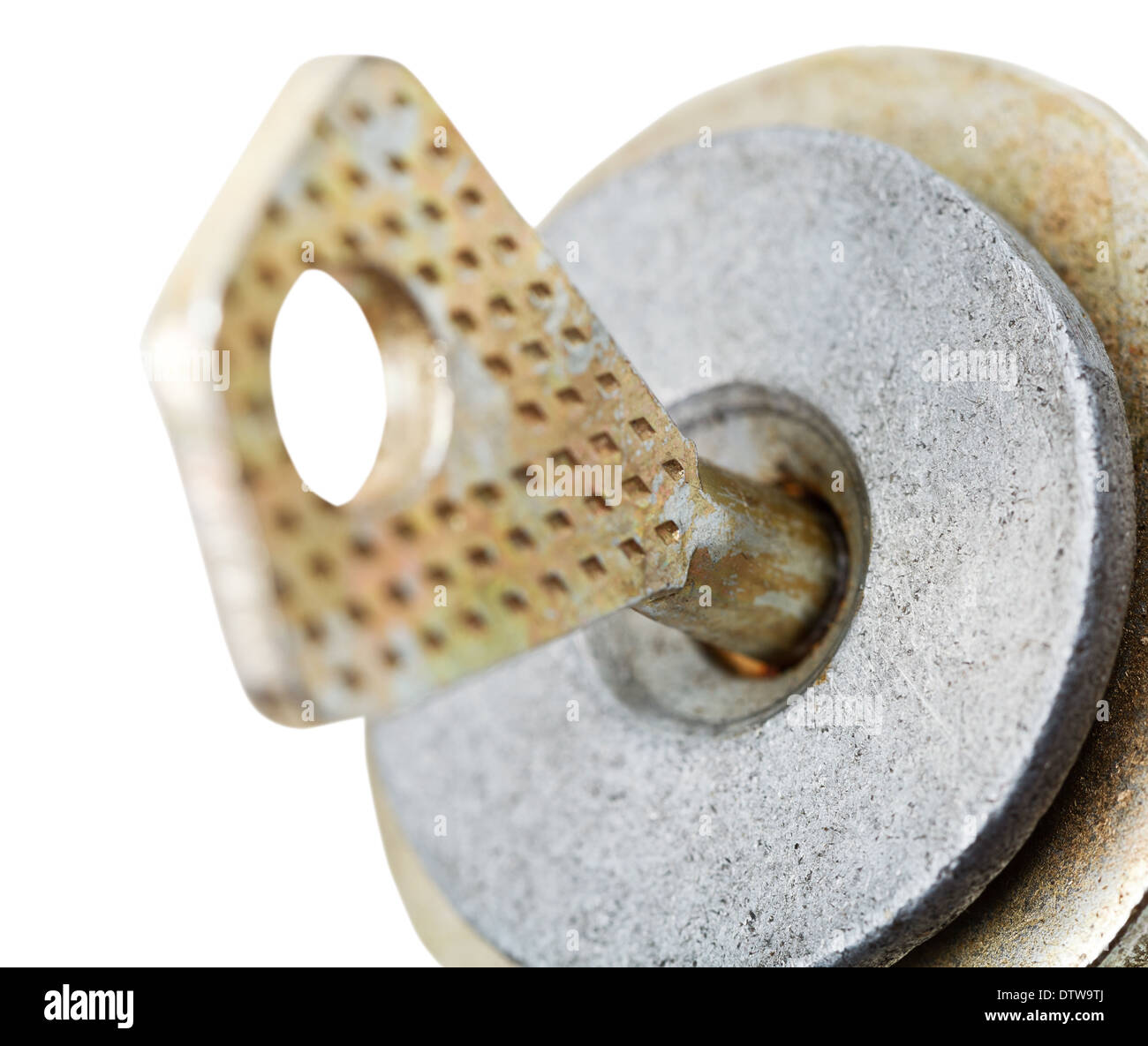 steel key in disc tumbler lock cylinder close up isolated on white