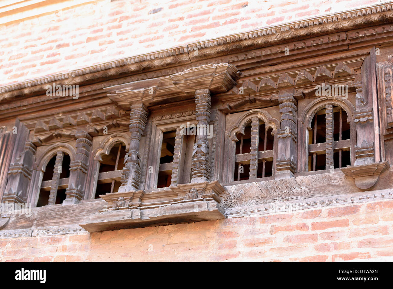 Carved wooden window on brick wall-Sadashiva Bhairab Chowk. Nyaynyapa Jhya-55 Window Palace. Durbar Square-Bhaktapur-Nepal. Stock Photo