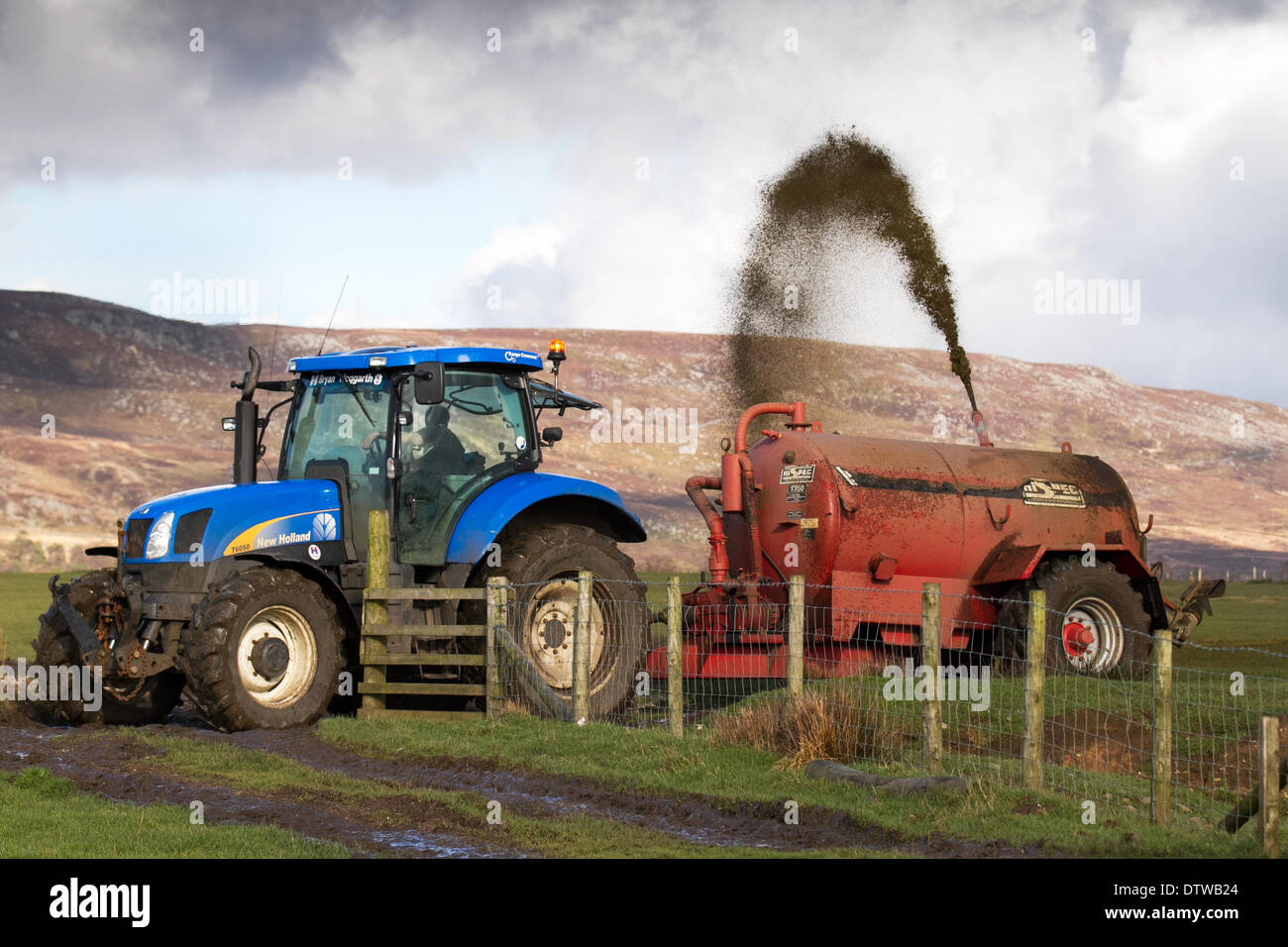 Farmers Muck Truck spreading agriculture silage effluent on waterlogged sodden fields during a