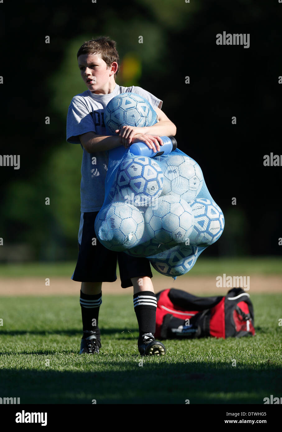 High school boy carrying soccer balls Stock Photo Alamy