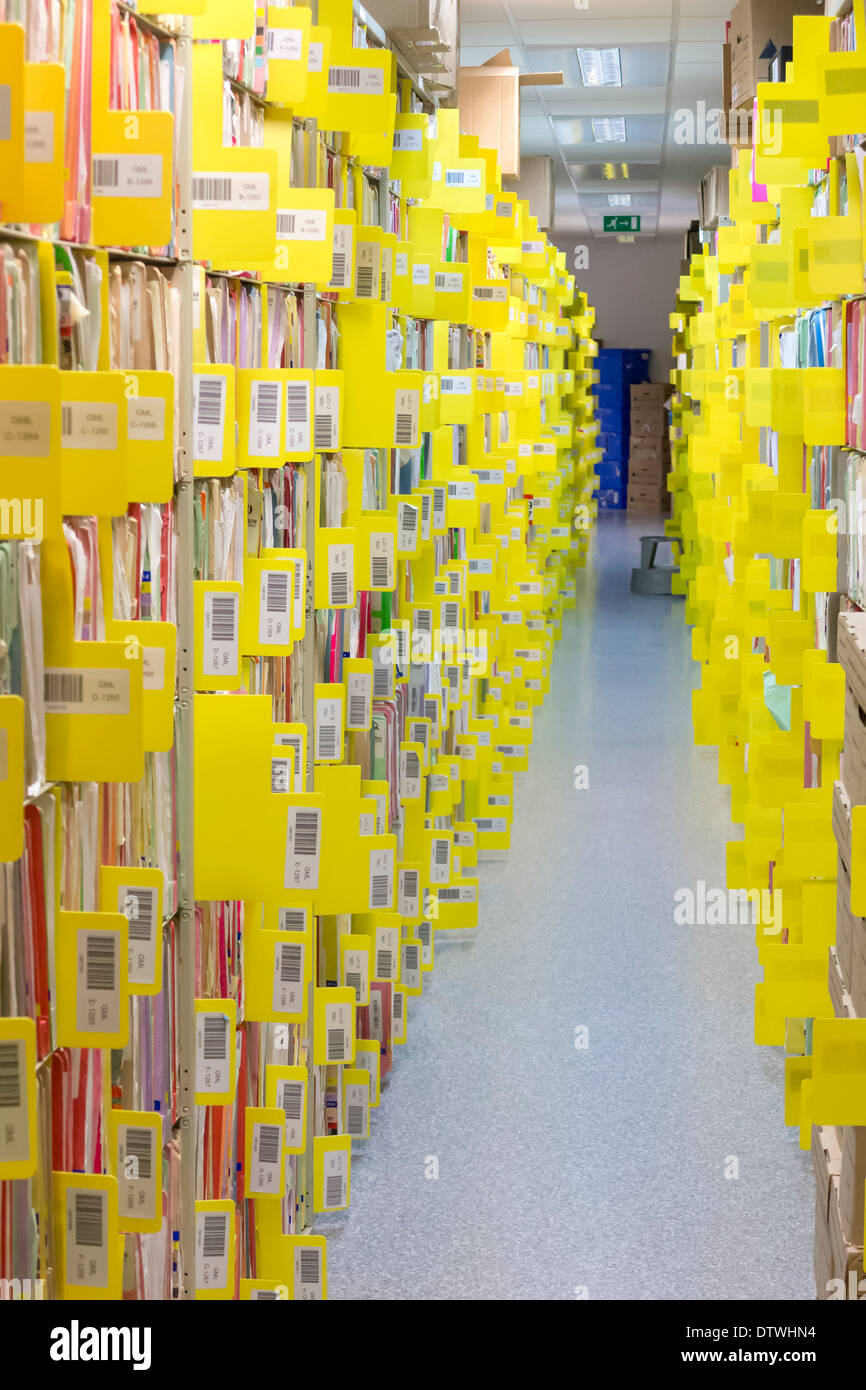 Rows of paper files containing patient records Stock Photo