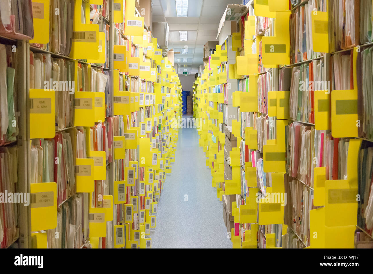 Rows of paper files containing patient records Stock Photo