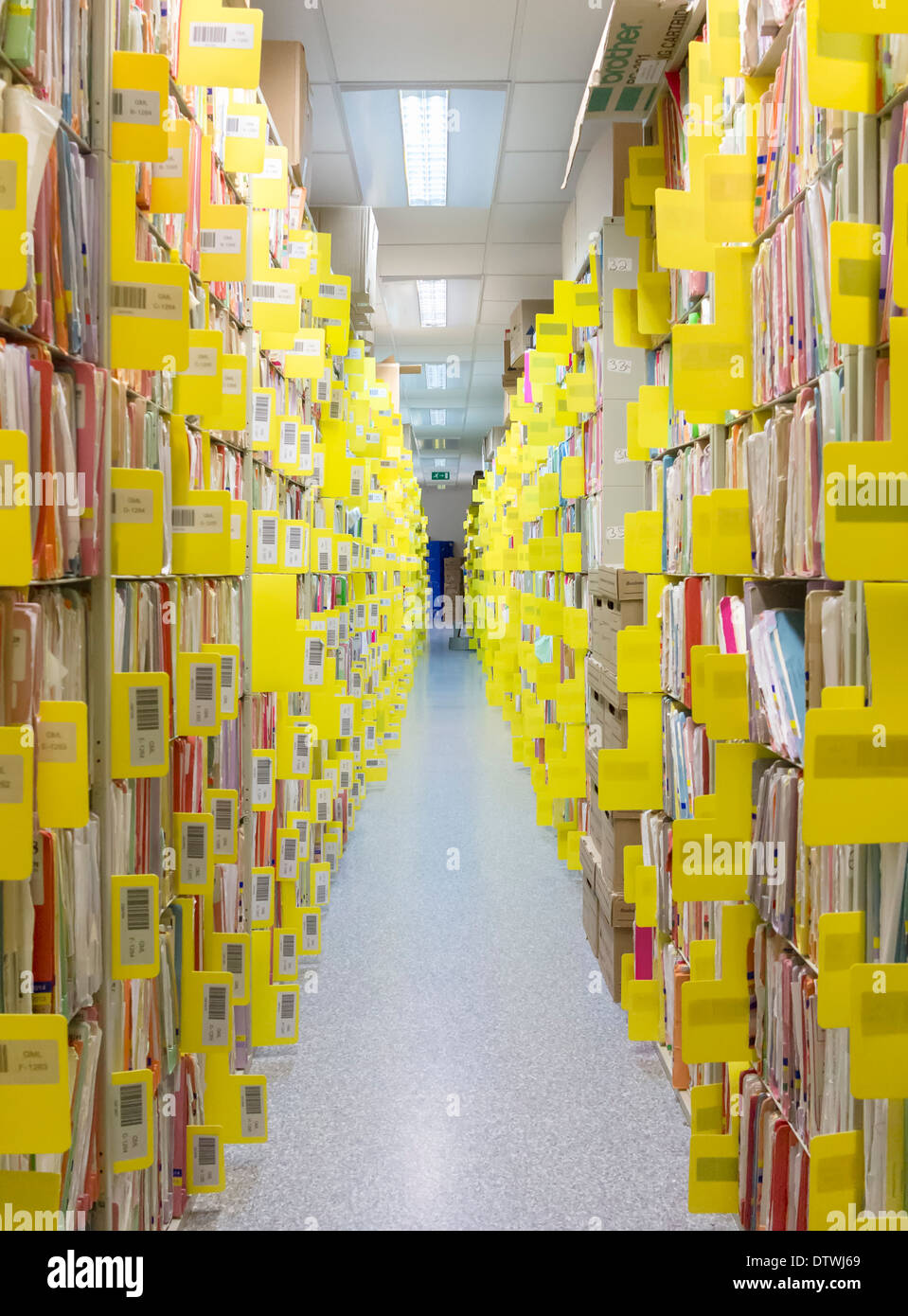Rows of paper files containing patient records Stock Photo