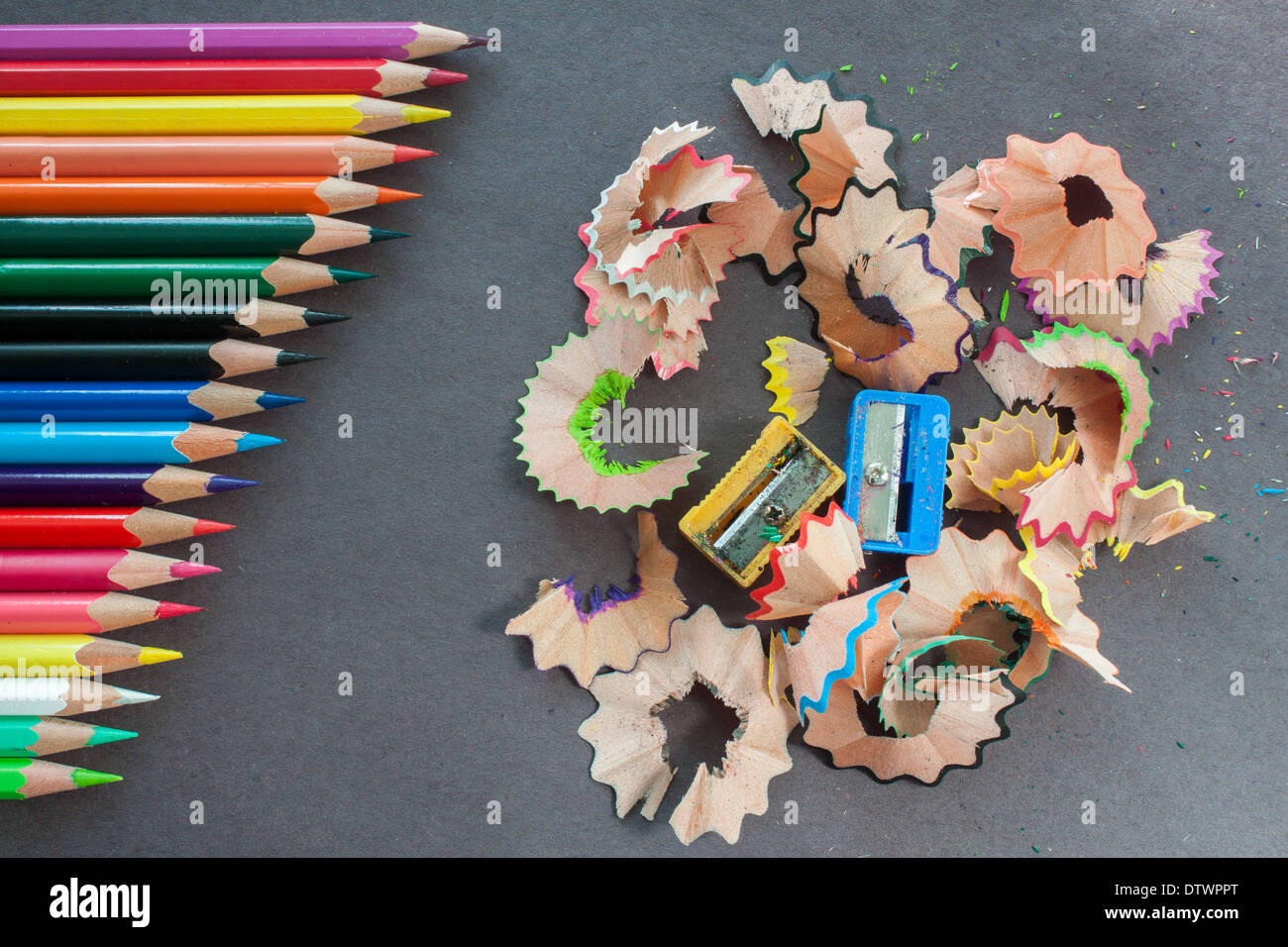 colorful pencils 'in a row' line sharp sharpen sharpeners trash closeup colors nobody 'dark background' rubbish Stock Photo