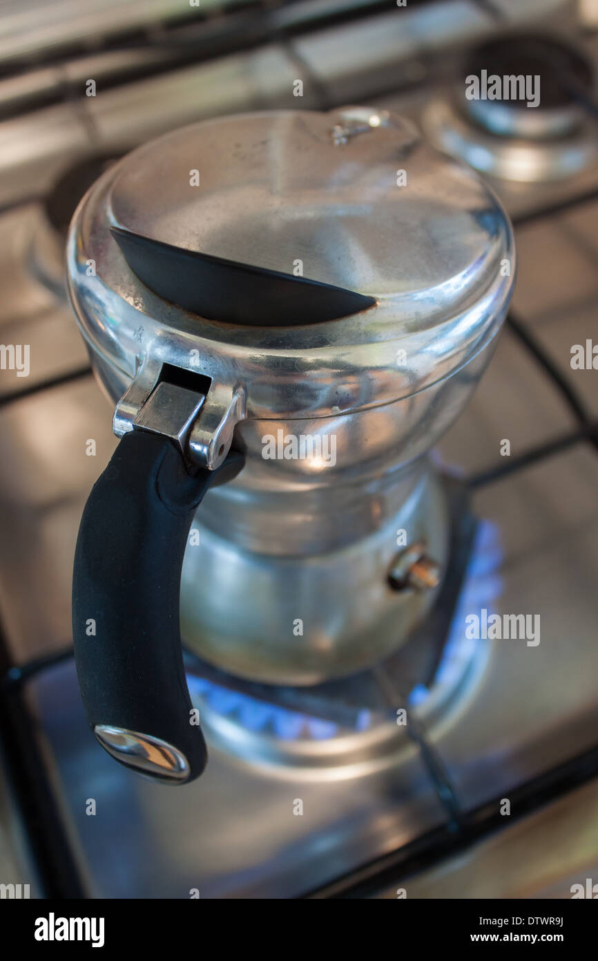 'coffee maker' cooking stove fire silver closeup making Stock Photo