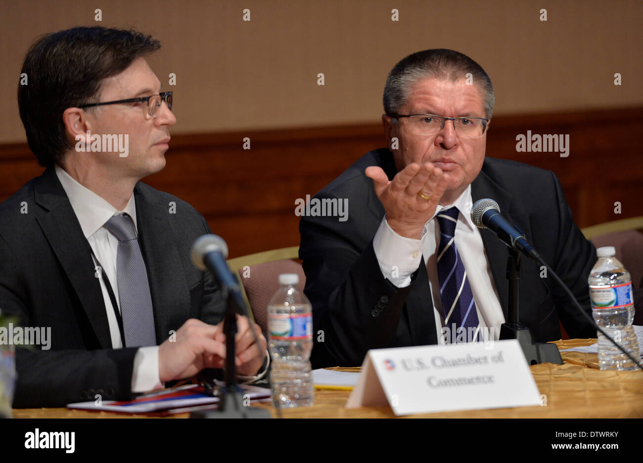Washington DC, USA. 24th Feb, 2014. Russian Economic Development Minister Alexei Ulyukaev (R) addresses a meeting held by the U.S. Chamber of Commerce in Washington DC, capital of the United States, Feb. 24, 2014. Alexei Ulyukaev said here on Monday that Russia's 15- billion-U.S. dollar bail-out funds for Ukraine will continue despite the current chaos, but Russia is waiting for the answer that who will be its Ukrainian partner. Credit:  Bao Dandan/Xinhua/Alamy Live News Stock Photo