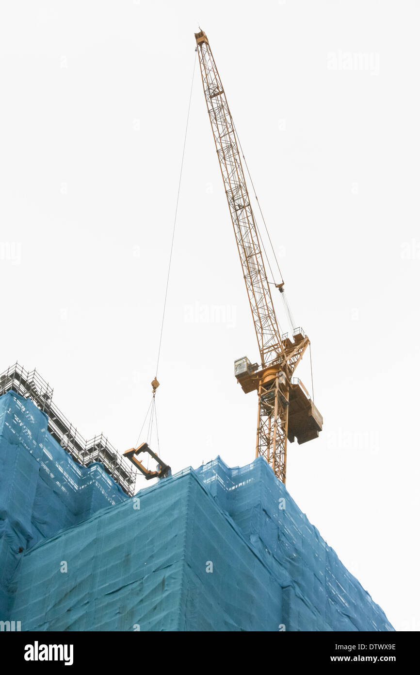 Crane on top of skyscraper Stock Photo Alamy