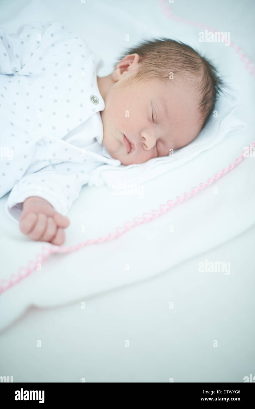 Sleeping newborn baby on bed hi-res stock photography and images - Alamy