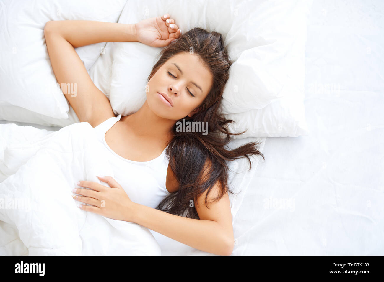 Beautiful girl sleeping in white bedding Stock Photo - Alamy