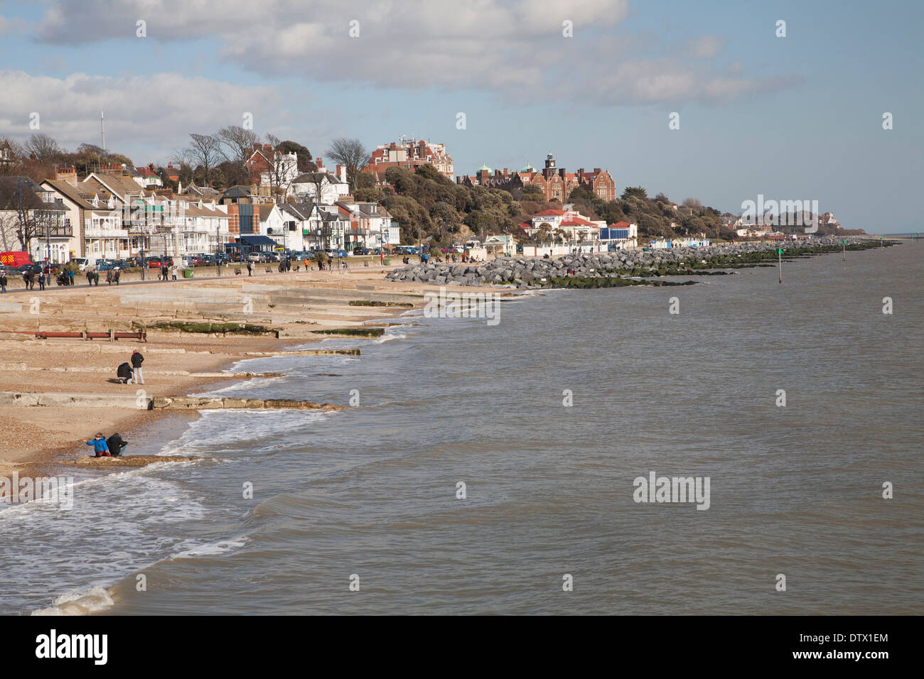 Sandy beach rock armour sea defences and historic buildings on the seafront on a sunny day in winter at Felixstowe, Suffolk, Stock Photo