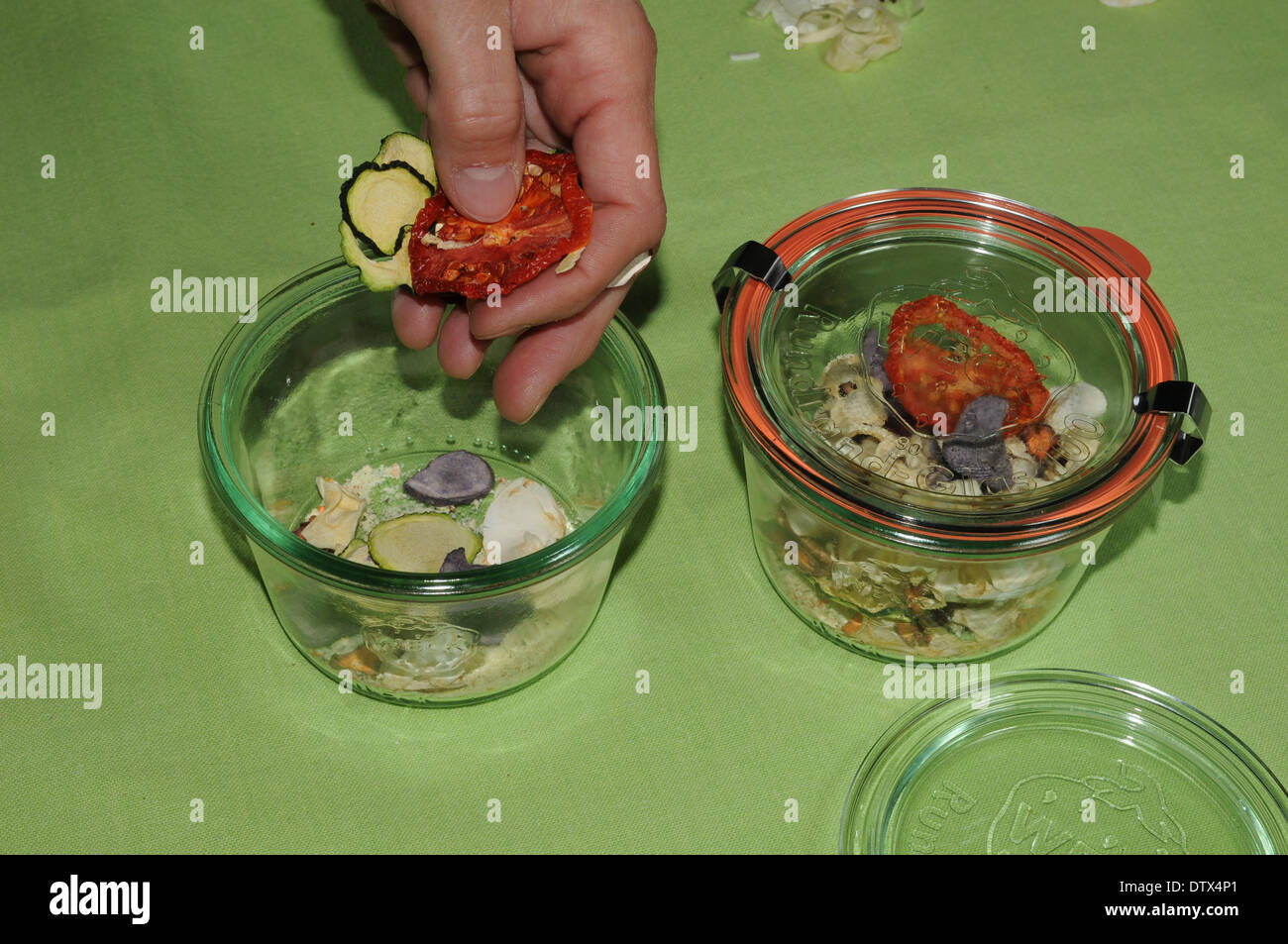 Filling dried vegetables in glasses Stock Photo