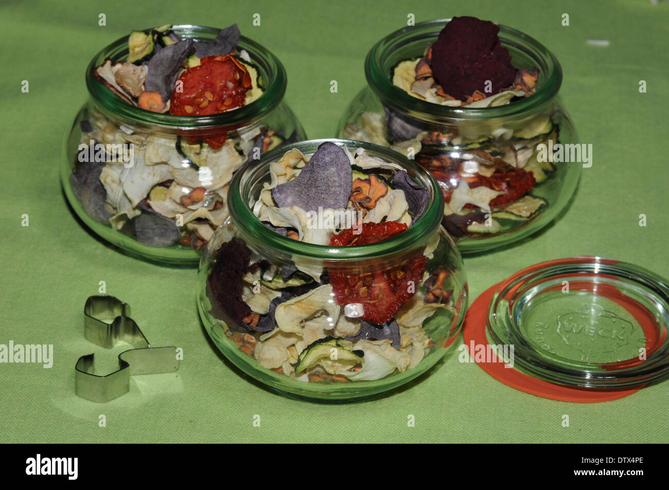 filling dries vegetables in glasses Stock Photo