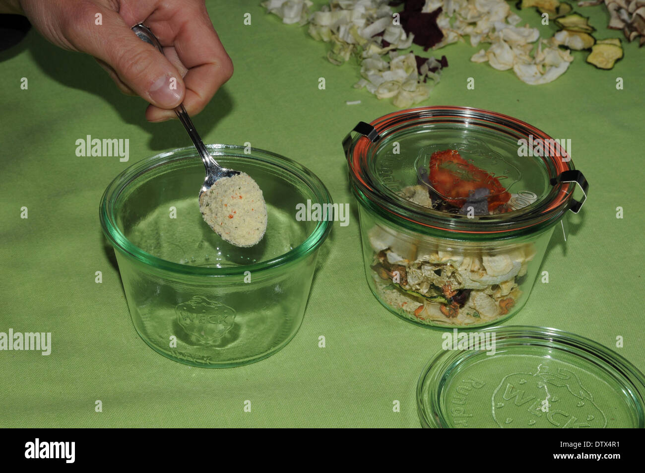 Filling soup-powder in a glass Stock Photo