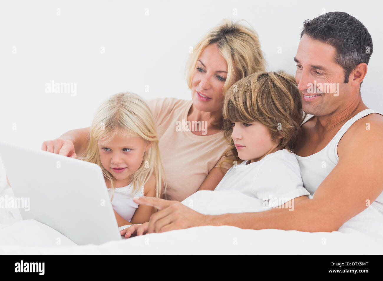 Family watching a laptop screen together Stock Photo