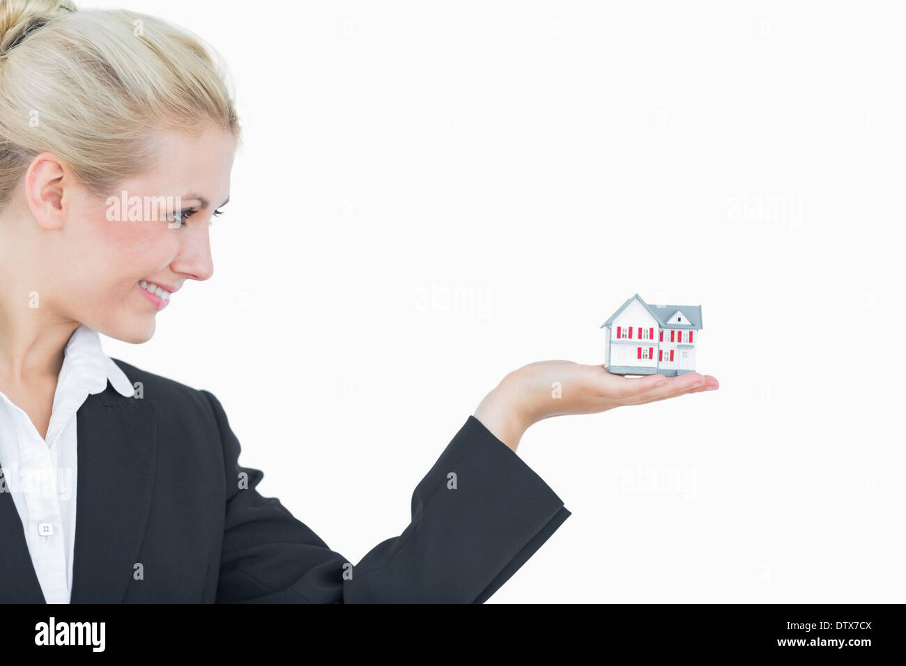 Happy business woman holding model house Stock Photo - Alamy