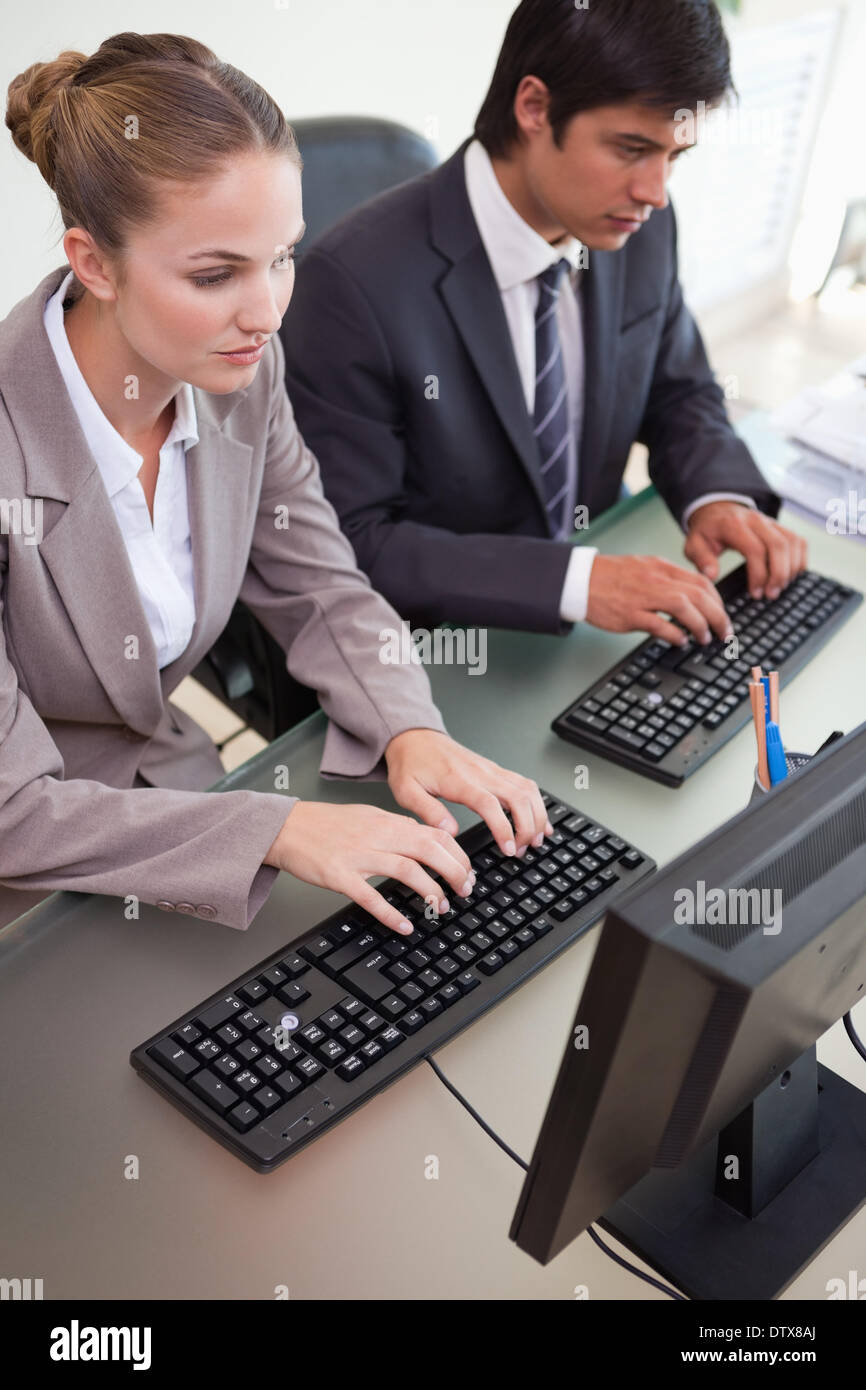 Corporate Work Using Computer Business colleagues using computers hi-res stock photography and images ...