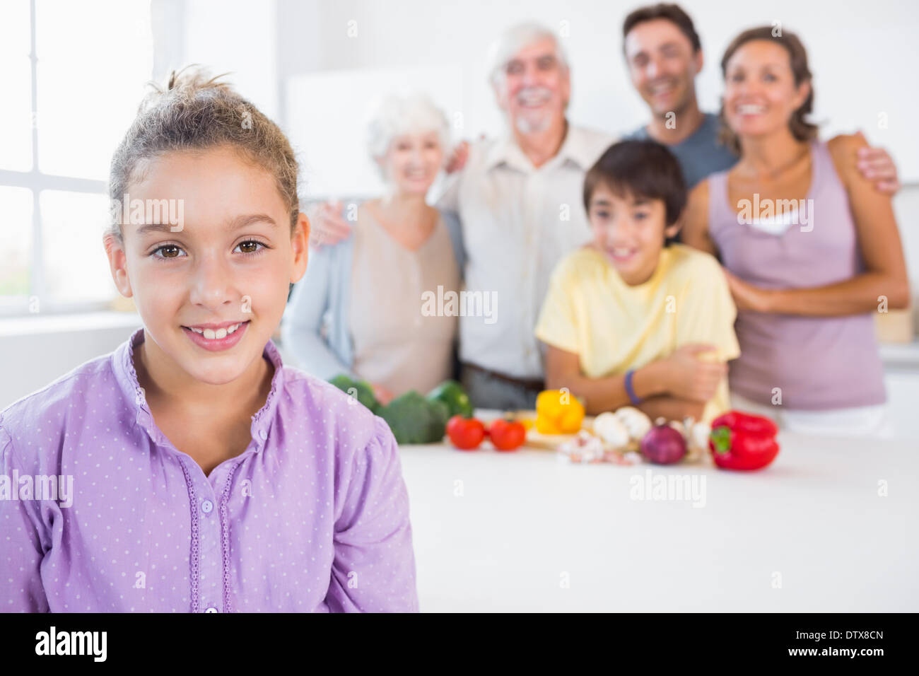 Young girl standing beside kitchen counter Stock Photo