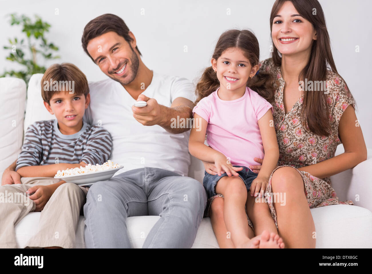 Happy family watching television together Stock Photo