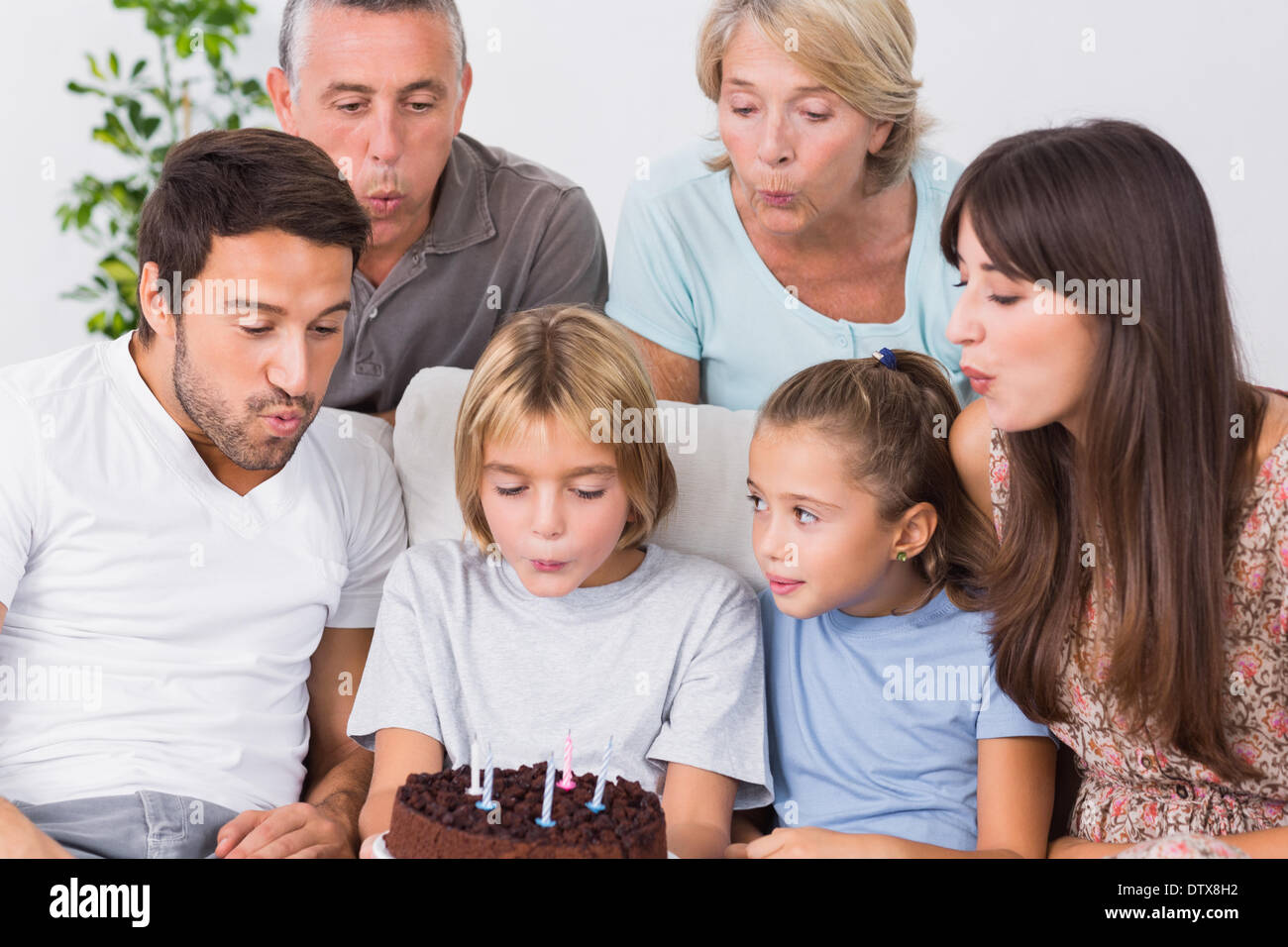 Little boy blowing out birthday candles Stock Photo Alamy