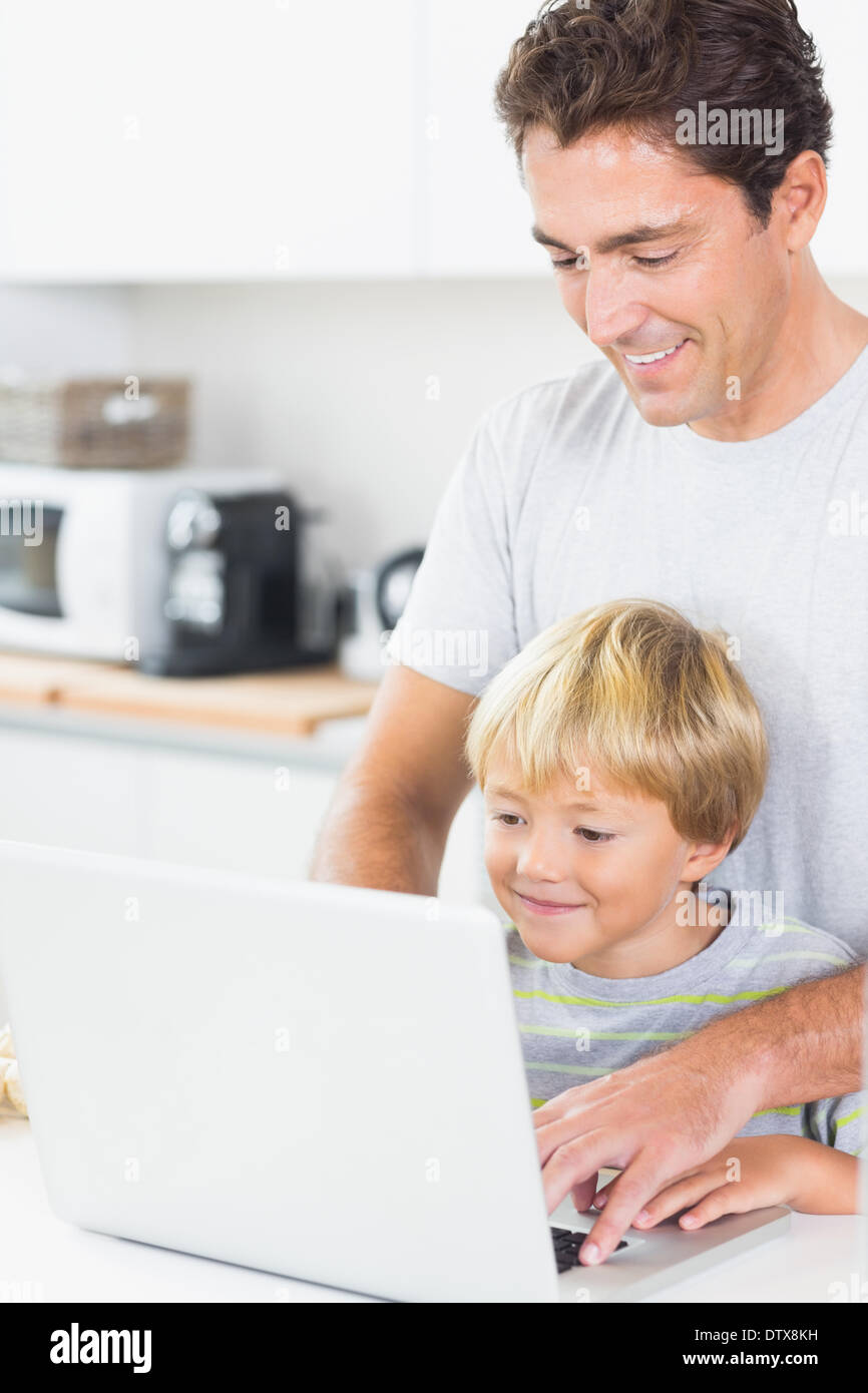 Father and son using laptop Stock Photo