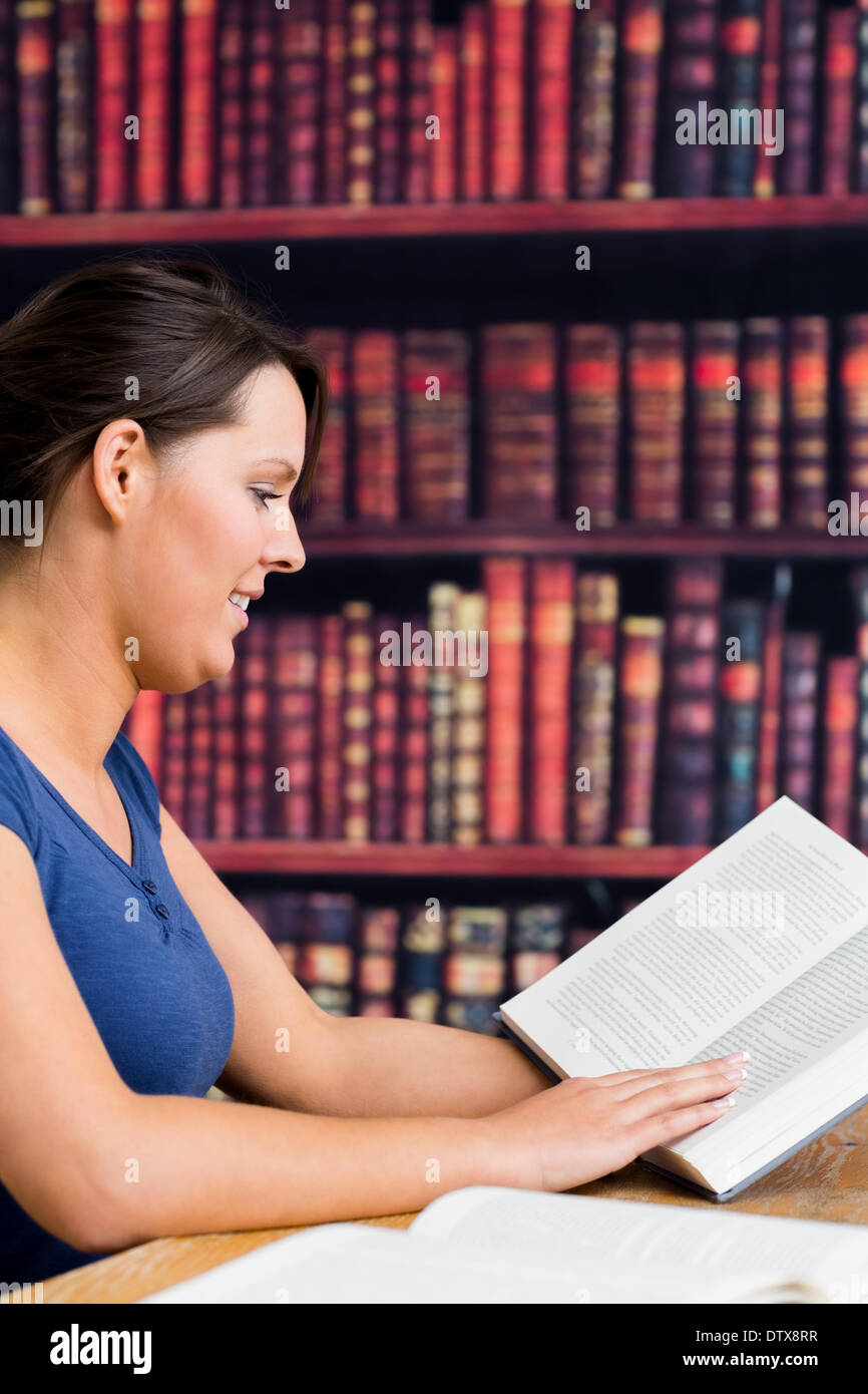 Cute girl smiling with book Stock Photo - Alamy