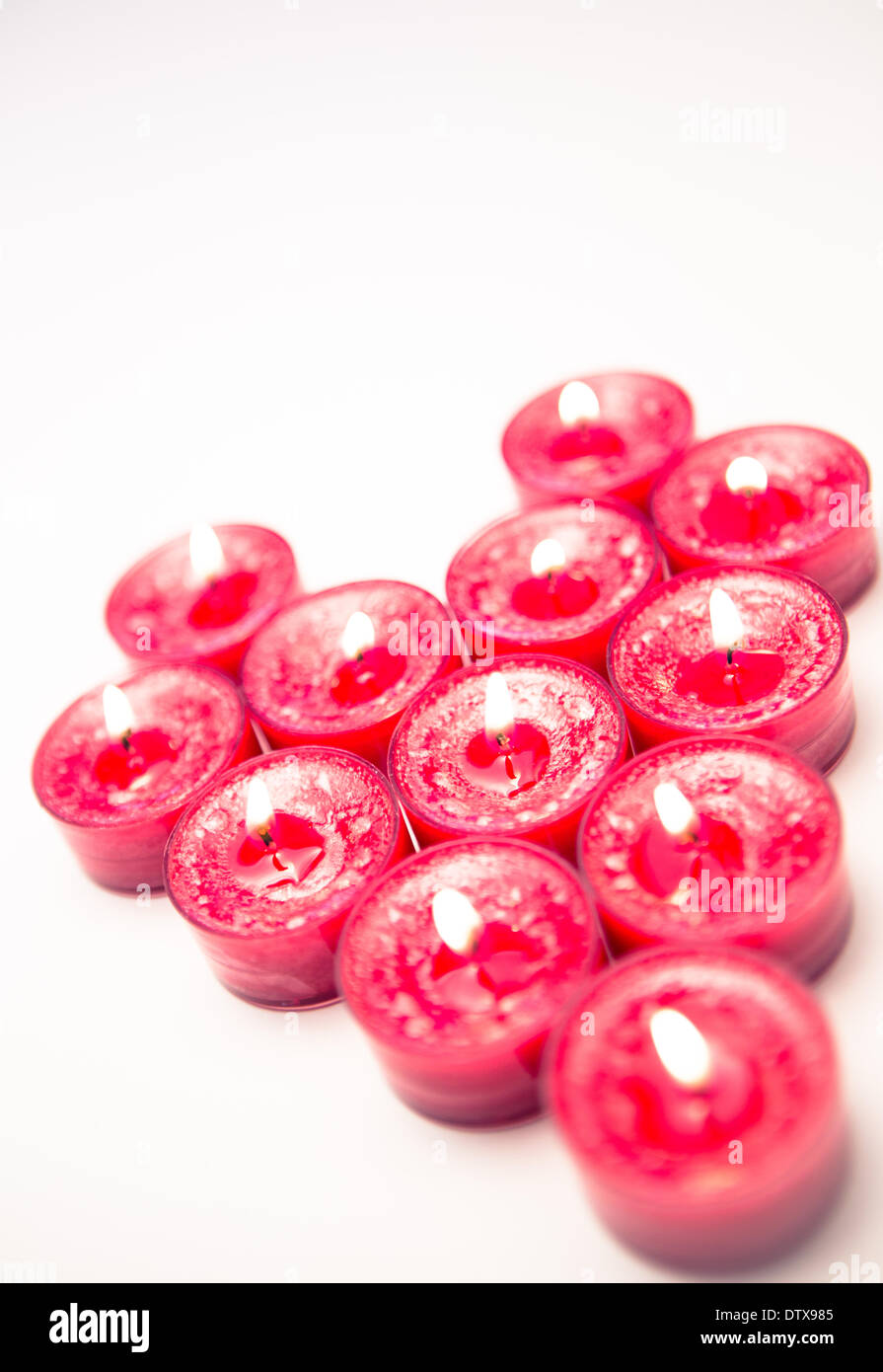Lit pink candles in heart shape Stock Photo Alamy
