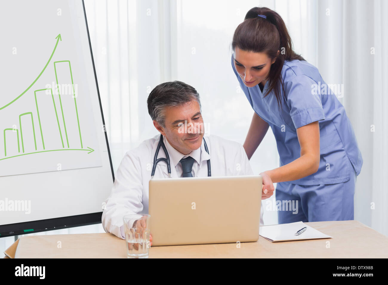 Nurse laptop typing scrubs hi-res stock photography and images - Alamy