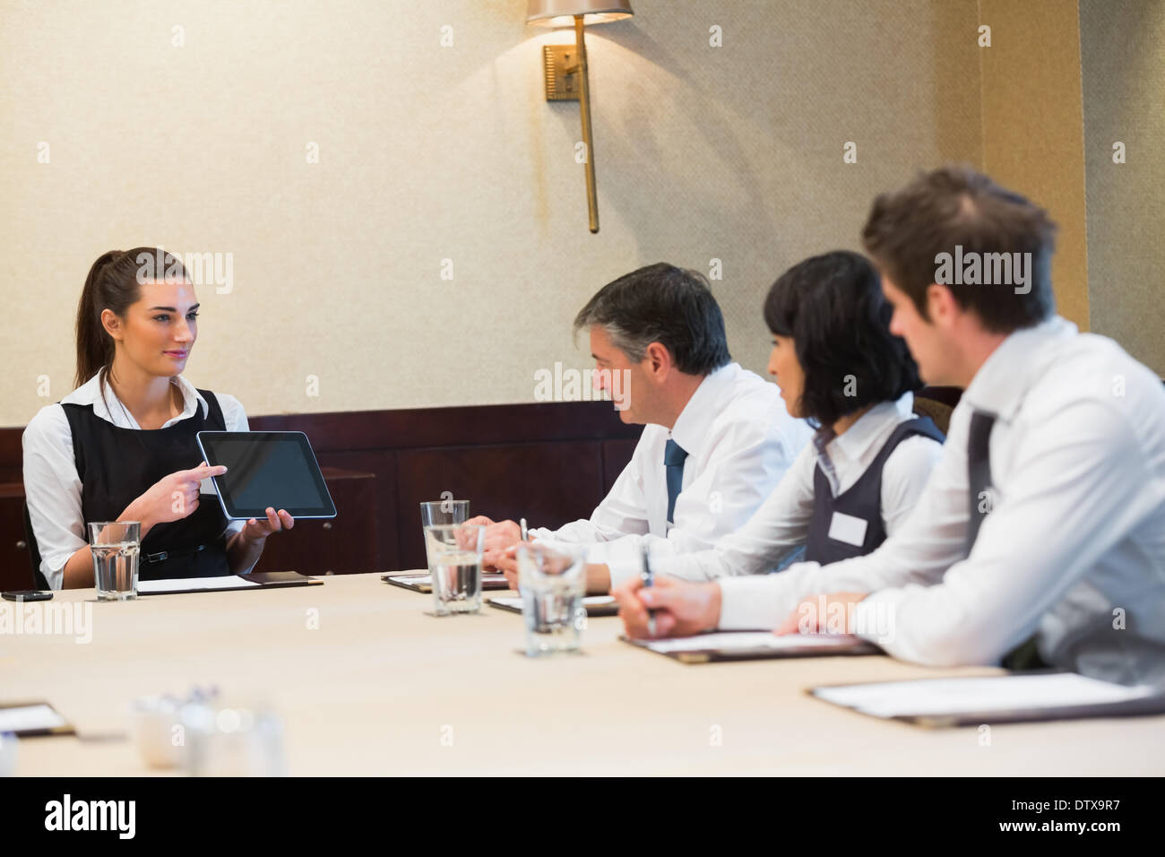 Businesswoman using tablet during presentation Stock Photo
