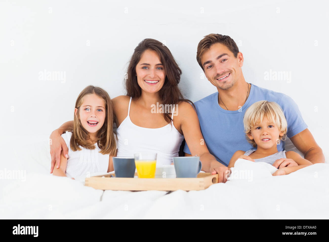 Family taking the breakfast on the bed Stock Photo