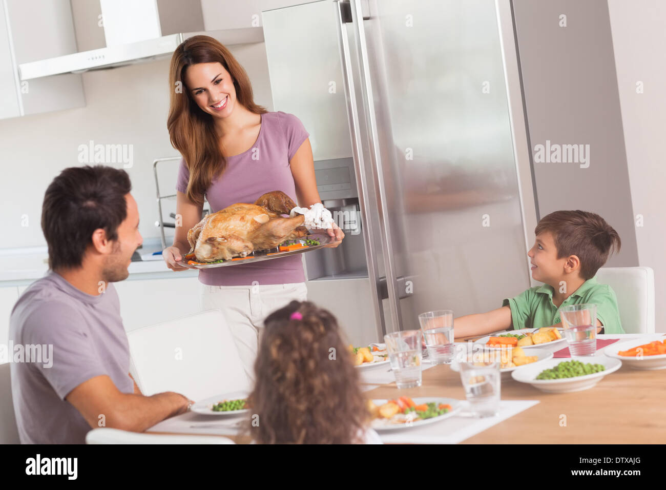 Mother carrying roast turkey for dinner Stock Photo Alamy