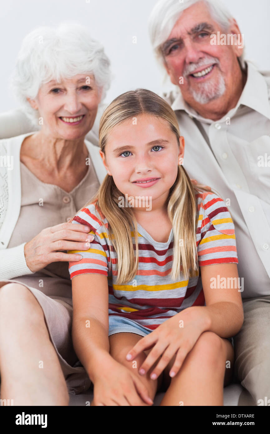 Granddaughter with grandparents on the sofa Stock Photo