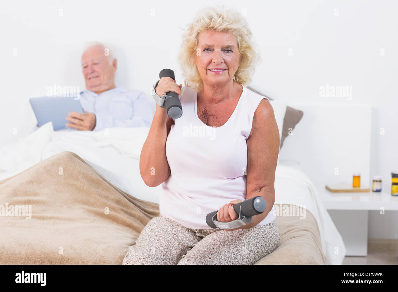 Elderly woman exercising with hand weights Stock Photo