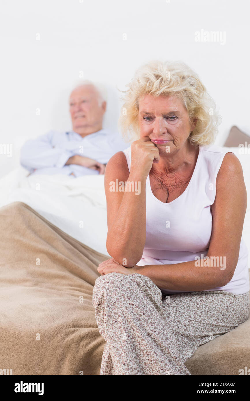 Discouraged old woman sitting Stock Photo