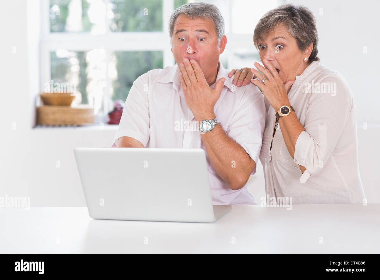 Old couple surprised in front of a laptop Stock Photo - Alamy