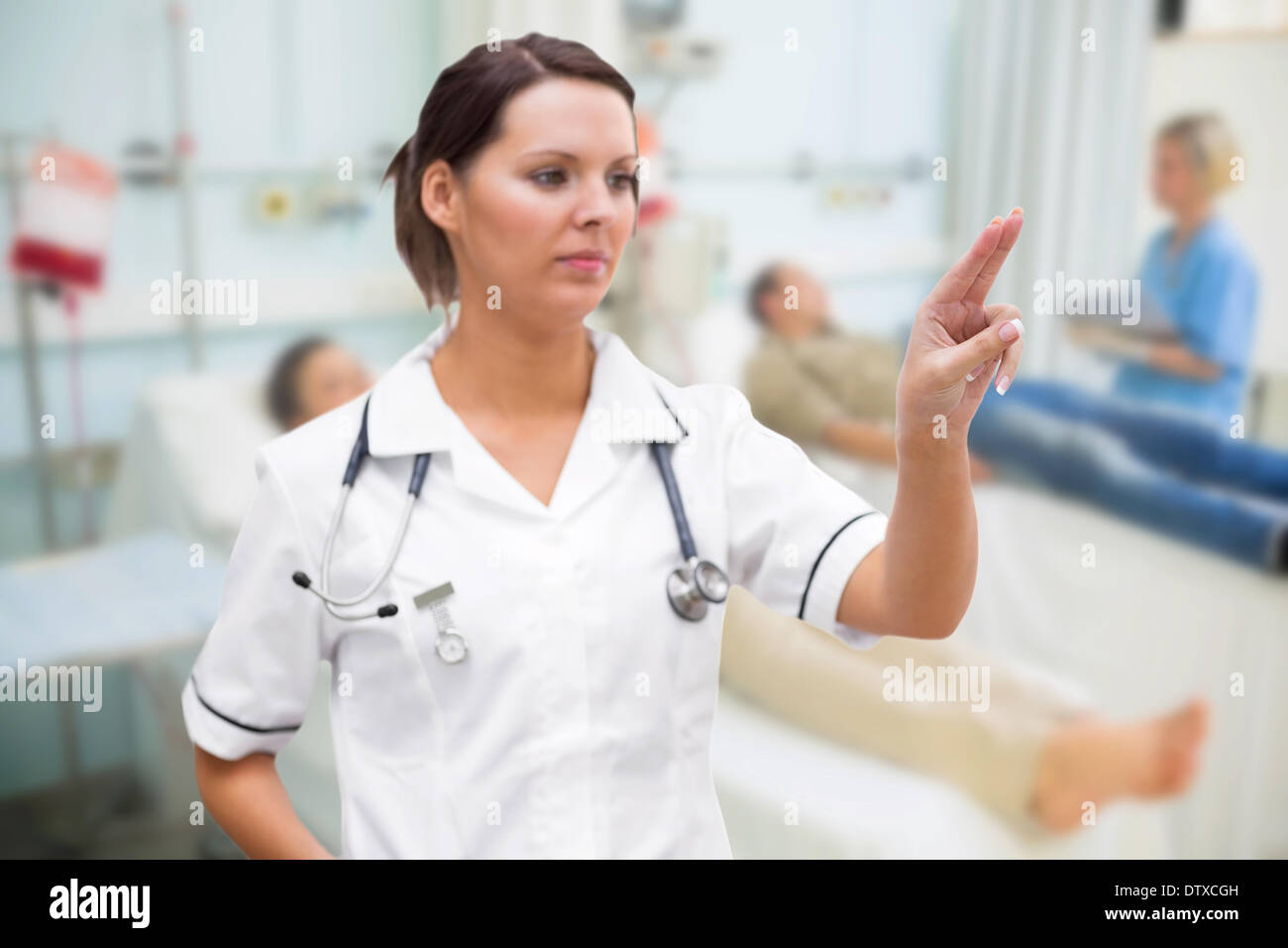 Nurse pressing on invisible screen Stock Photo