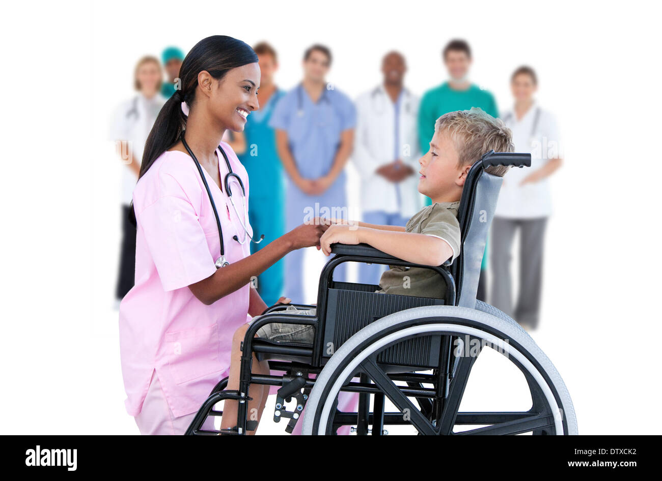 Nurse chatting with little boy in wheelchair Stock Photo
