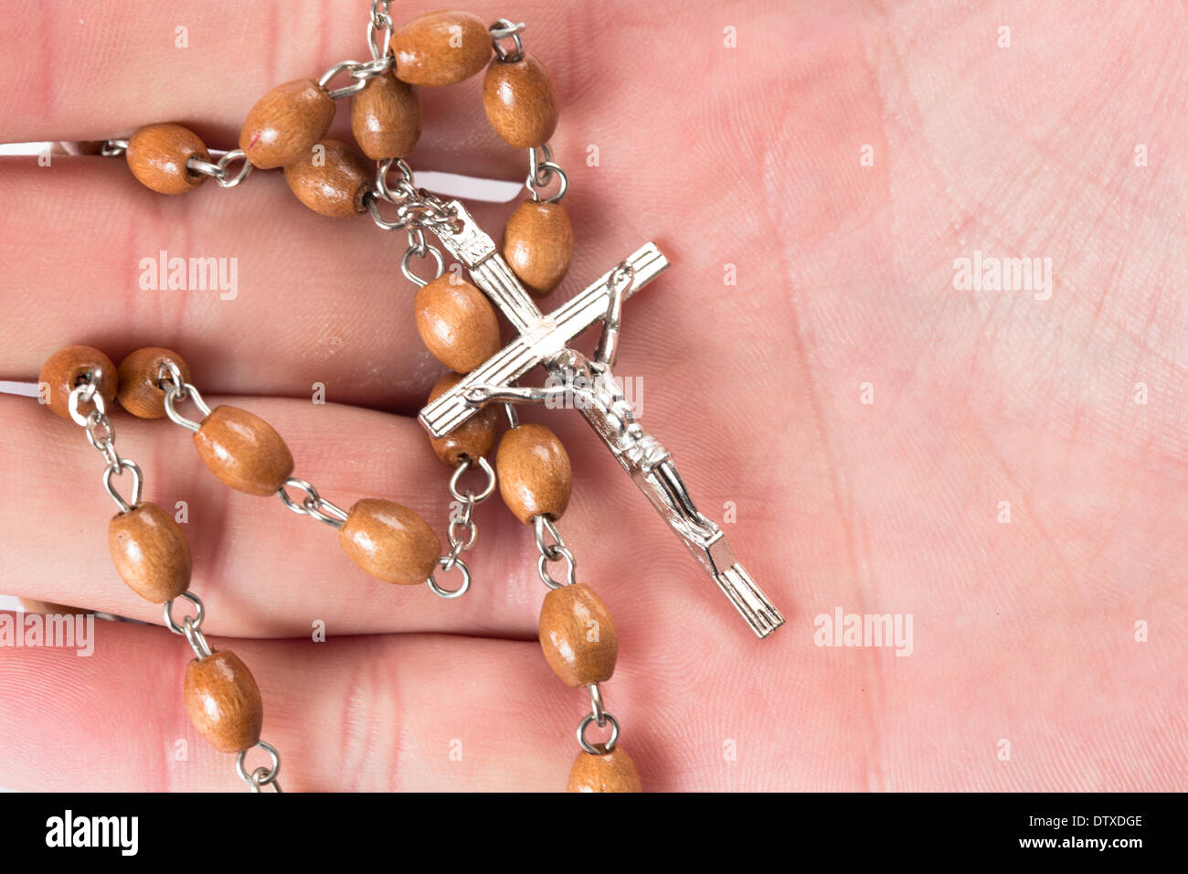 Rosary beads in someones hand Stock Photo Alamy