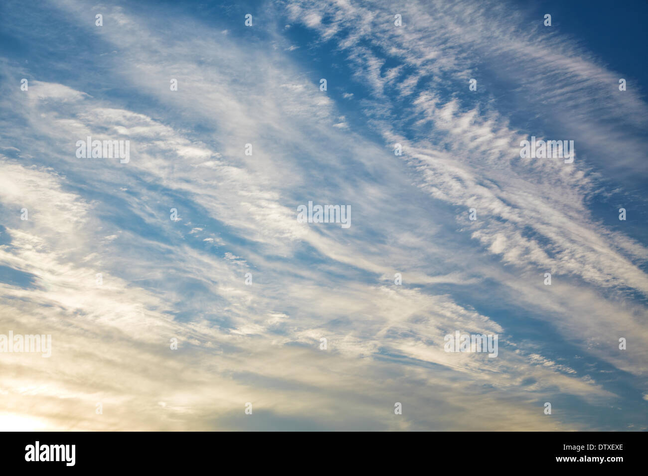 Plumose clouds in beams of the coming sun Stock Photo