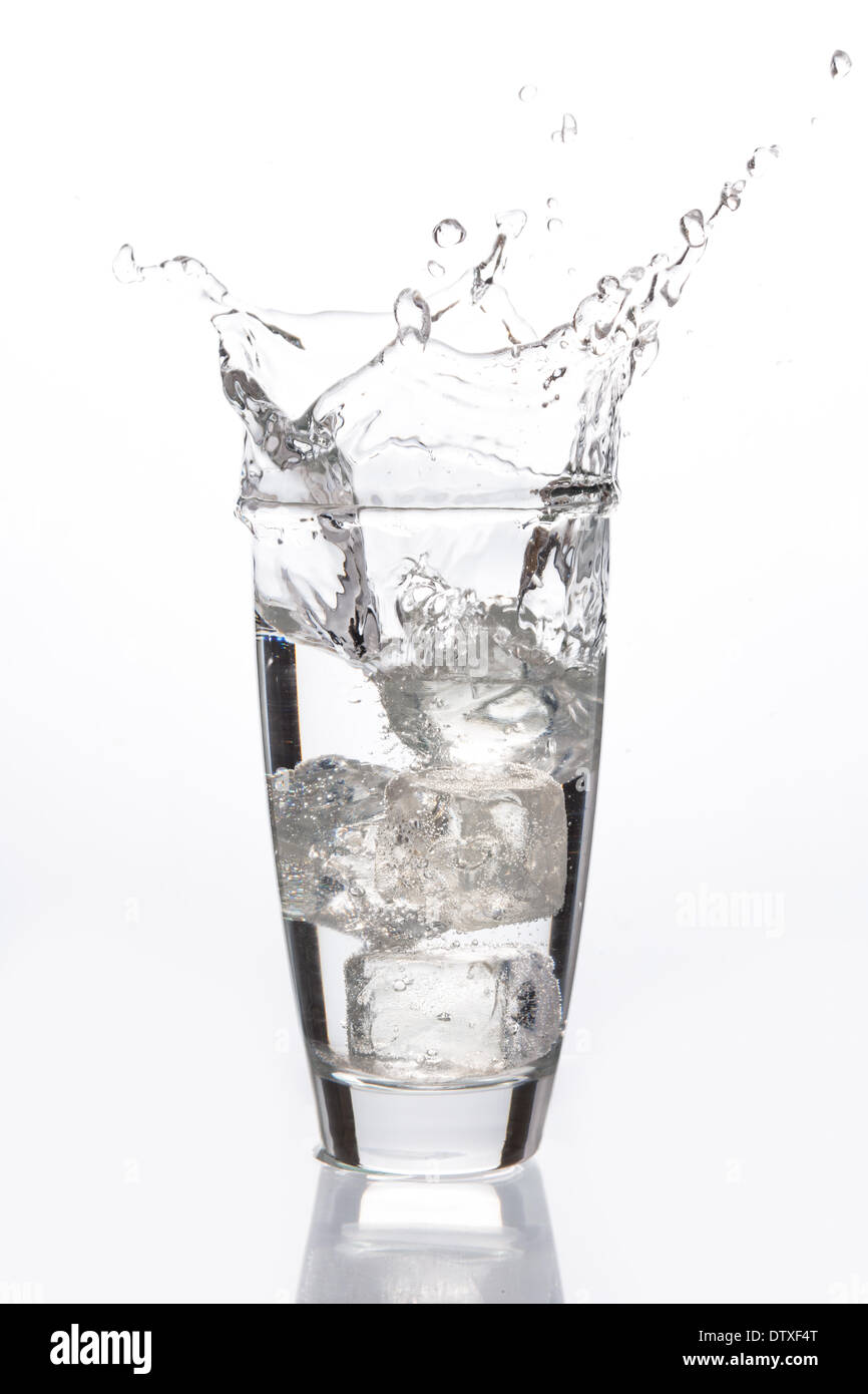 Ice cube falling into glass Stock Photo - Alamy