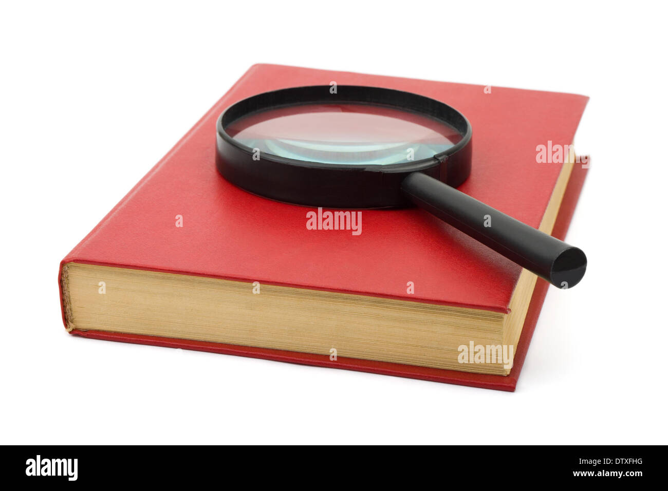 Magnifying glass on book Stock Photo - Alamy