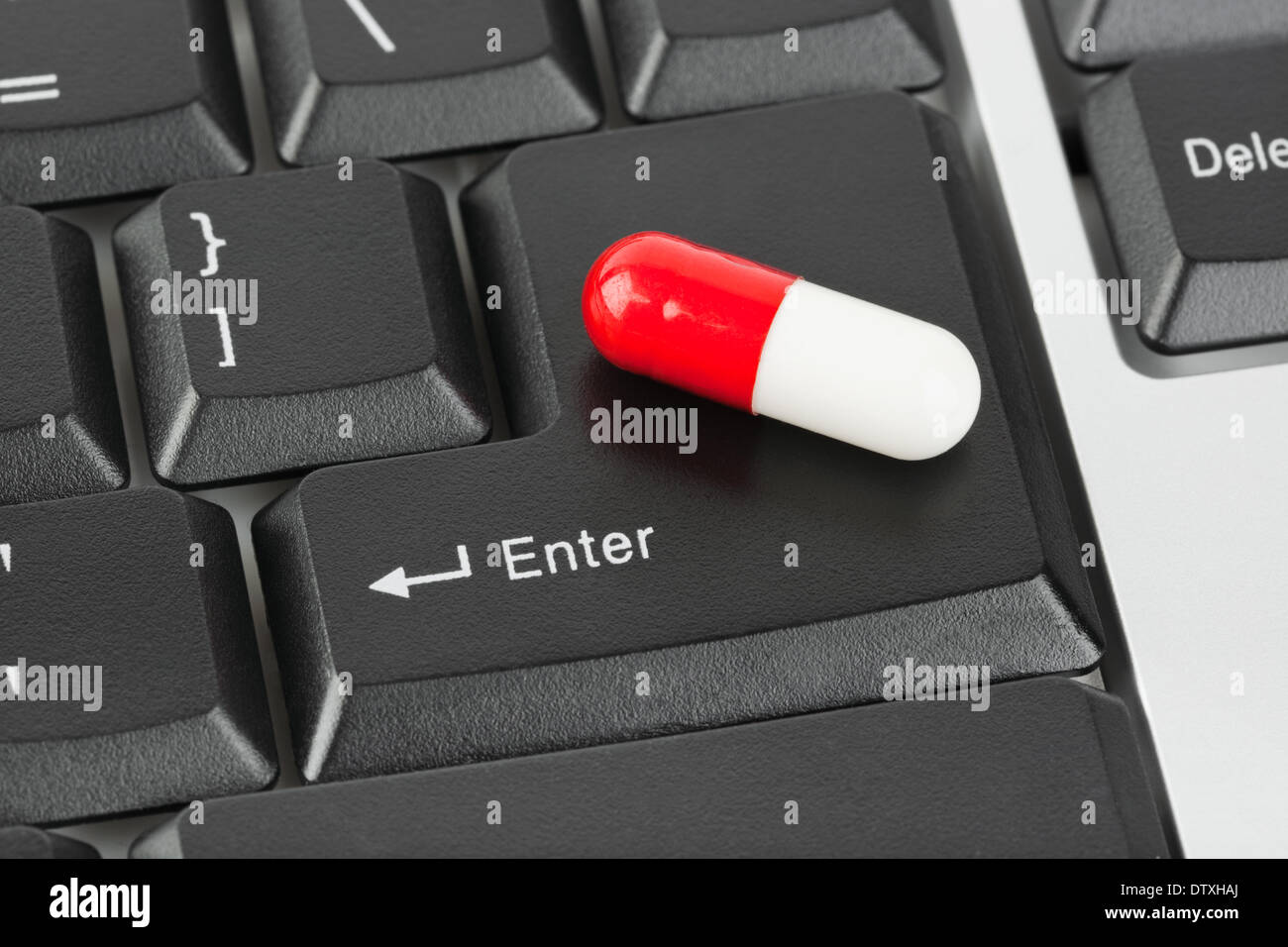 Pill on computer keyboard Stock Photo Alamy